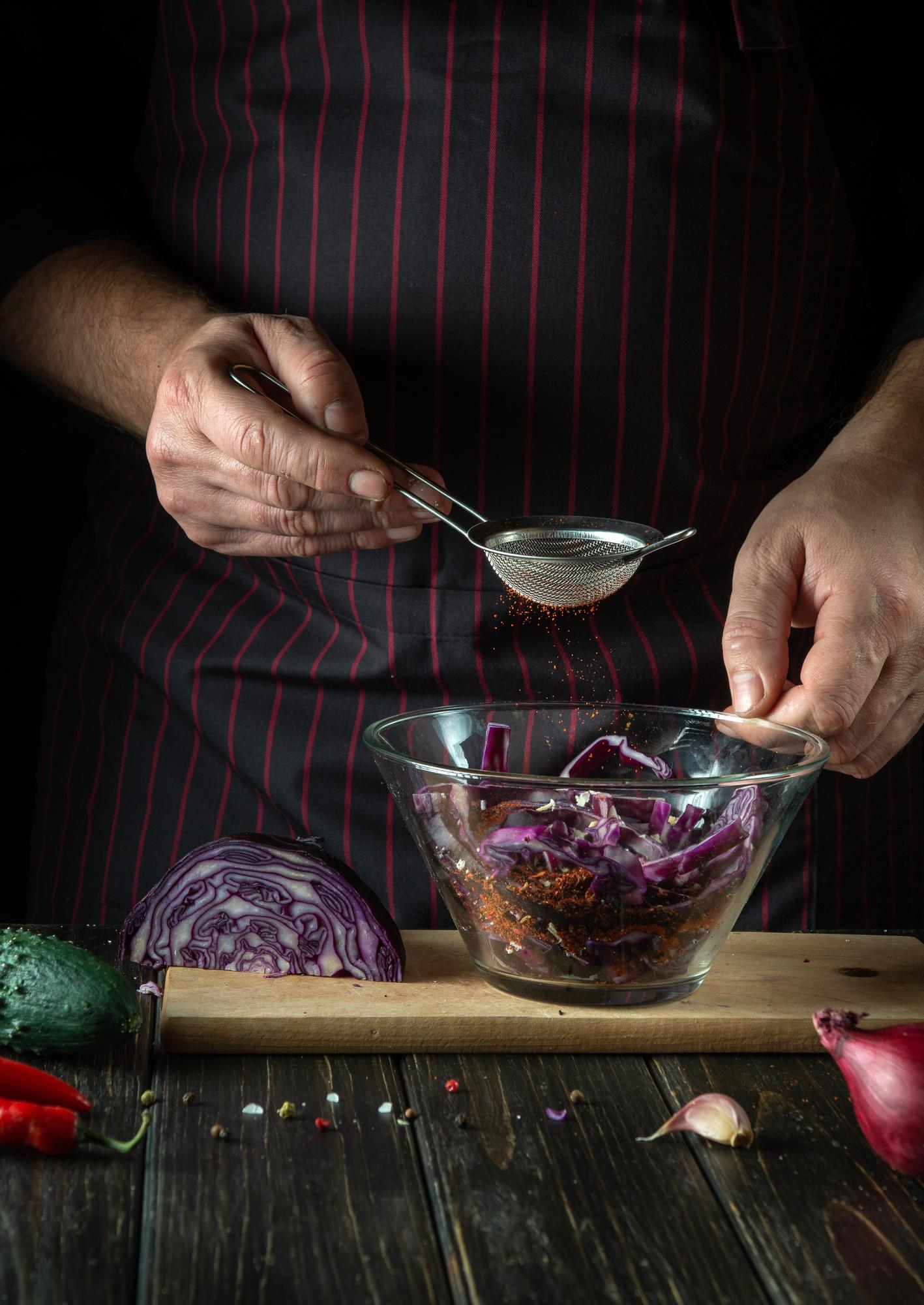 artisan chef preparing meal in small kitchen